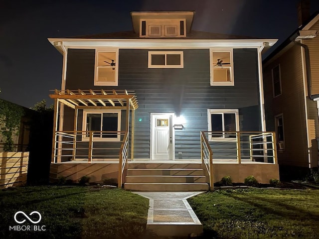 view of front of home with a yard and a pergola