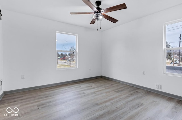 spare room featuring light wood-type flooring and ceiling fan