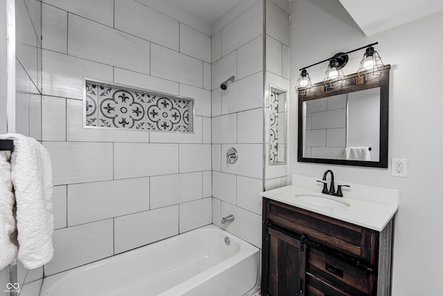 bathroom with vanity and tiled shower / bath