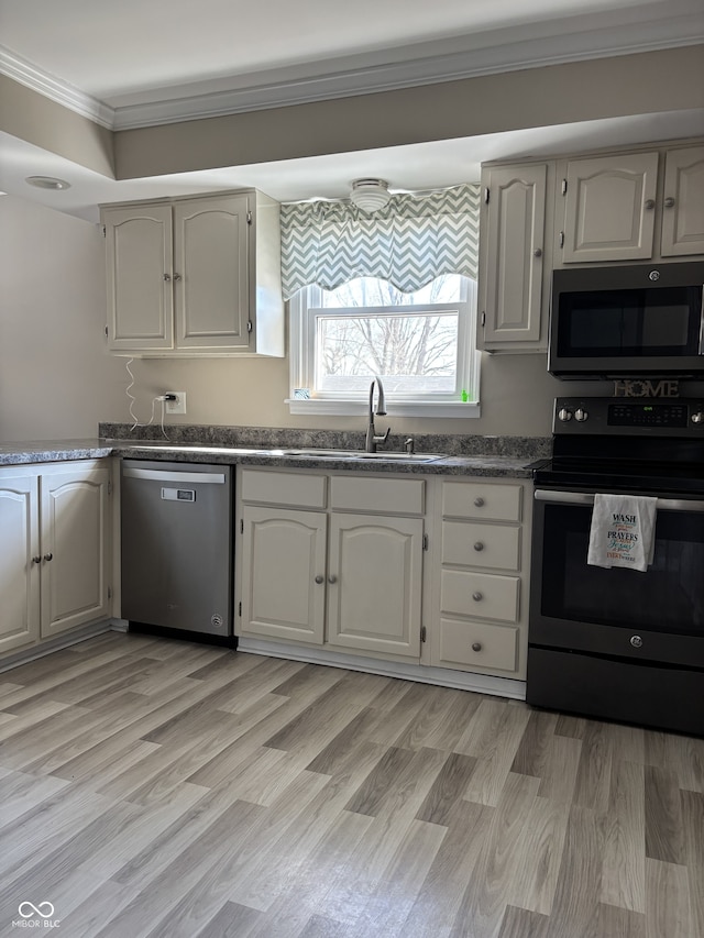 kitchen with range with electric stovetop, dark countertops, ornamental molding, a sink, and dishwasher