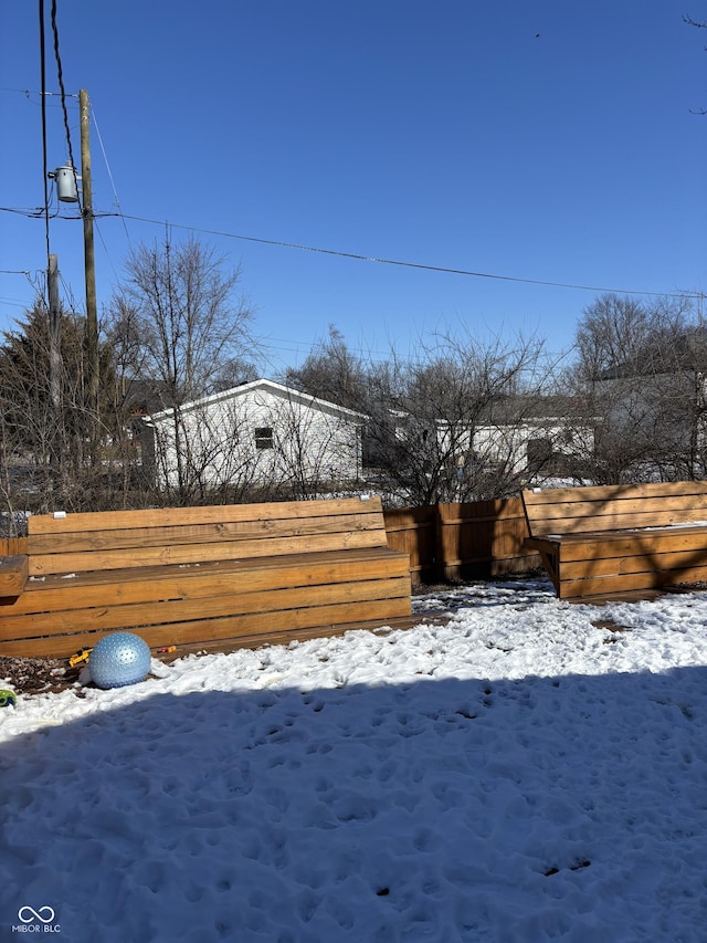 snowy yard with fence