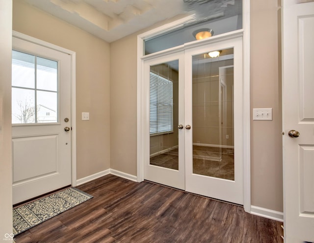 entryway with french doors, dark wood finished floors, and baseboards