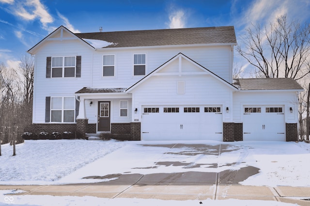 view of front of house featuring an attached garage and brick siding