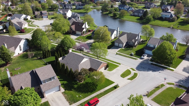 birds eye view of property with a water view and a residential view