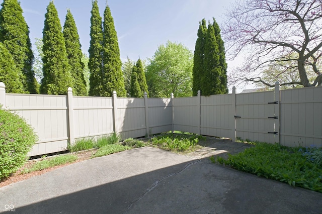 view of patio with fence and a gate