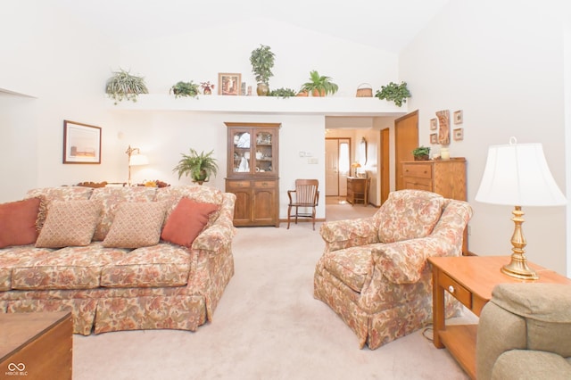 living room featuring light colored carpet and high vaulted ceiling