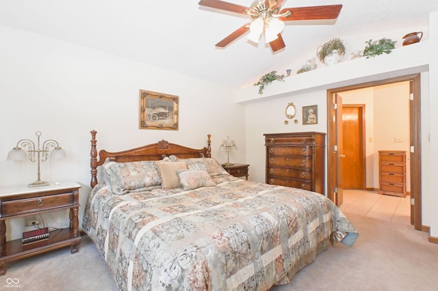 carpeted bedroom with a ceiling fan and lofted ceiling