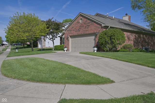 view of side of property featuring a garage, a yard, and brick siding