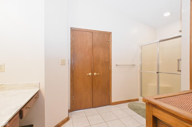 bathroom featuring vanity, baseboards, recessed lighting, tile patterned floors, and a shower stall
