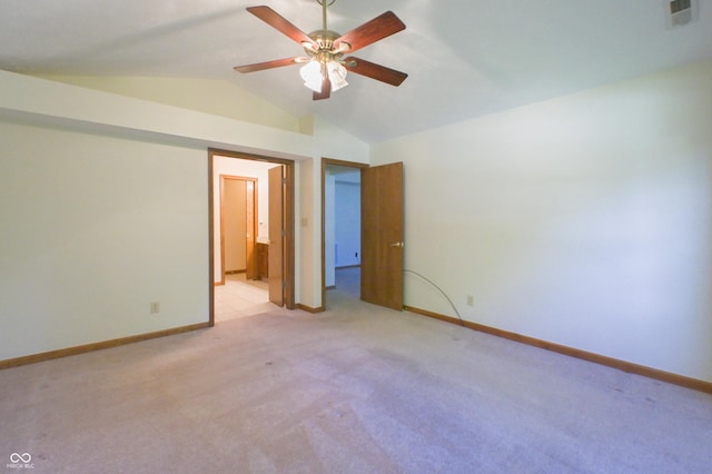 unfurnished bedroom with baseboards, visible vents, light colored carpet, and lofted ceiling