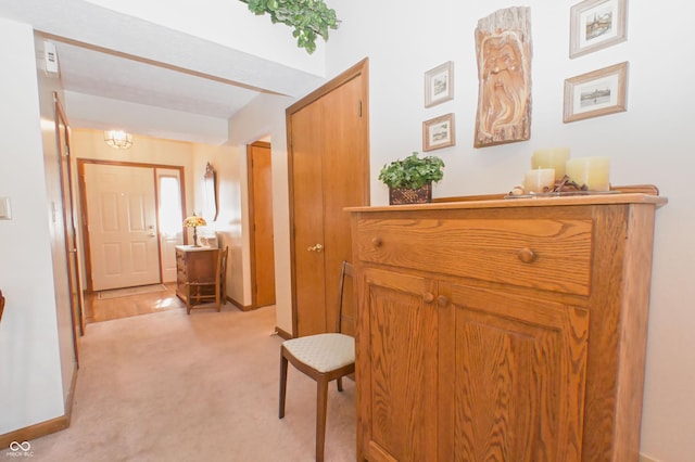 hallway featuring light colored carpet