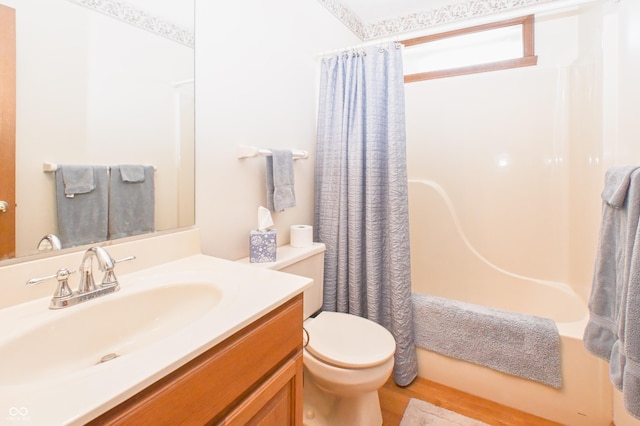 bathroom with vanity, shower / bathtub combination with curtain, and toilet