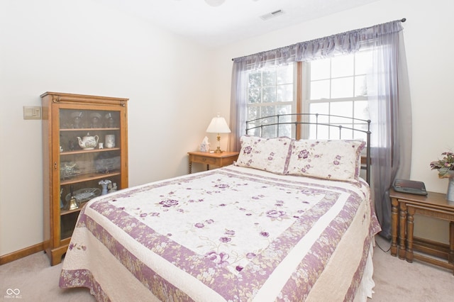 bedroom featuring light carpet and visible vents
