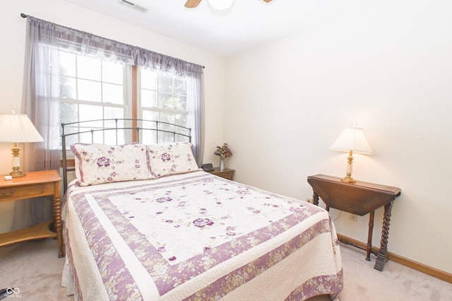 bedroom featuring visible vents, a ceiling fan, baseboards, and carpet floors