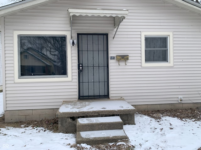 view of snow covered property entrance