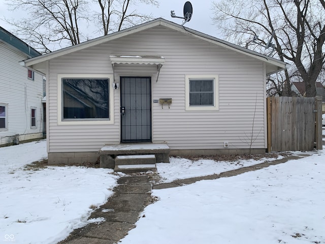 bungalow-style home featuring fence