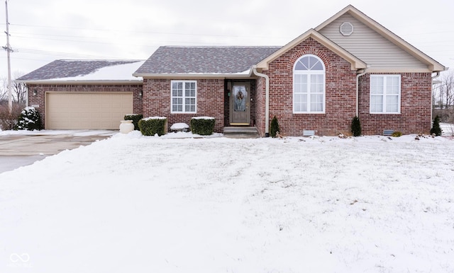 ranch-style home with crawl space, an attached garage, and brick siding