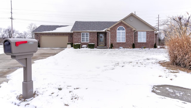 single story home with a garage, driveway, and brick siding