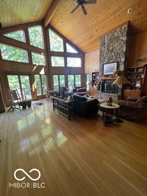 living room featuring beam ceiling, high vaulted ceiling, hardwood / wood-style flooring, and wood ceiling