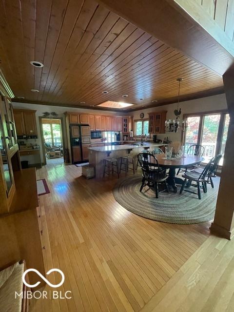 dining room with wooden ceiling and light hardwood / wood-style floors