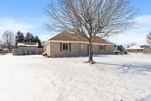 view of snow covered back of property