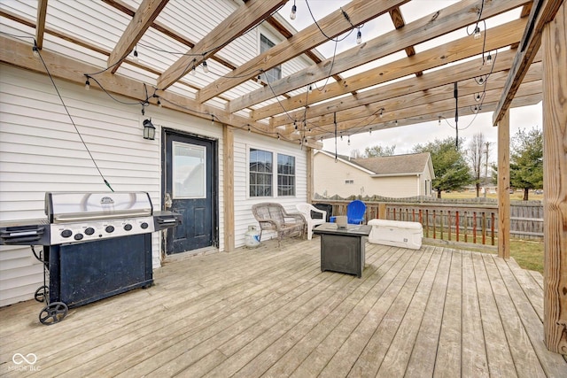 wooden deck featuring a pergola, a grill, and a fire pit