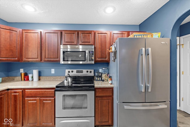 kitchen featuring stainless steel appliances and a textured ceiling