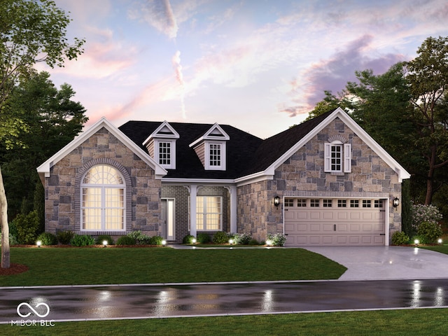 view of front of home with a garage and a lawn