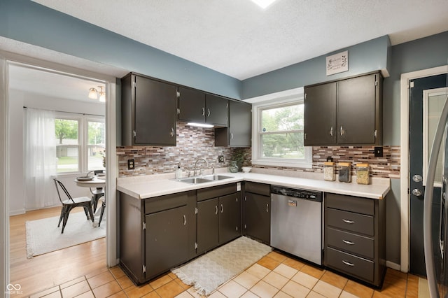 6865 Meadow View Dr, Lawrence, IN 46226 - kitchen featuring dishwasher, healthy amount of natural light, tasteful backsplash, light countertops, and a textured ceiling