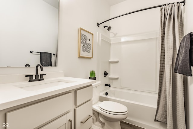 bathroom featuring toilet, shower / bath combo with shower curtain, and vanity