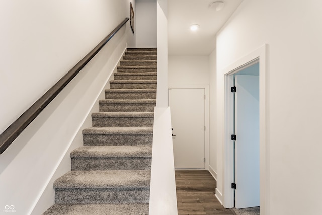 stairs featuring wood finished floors