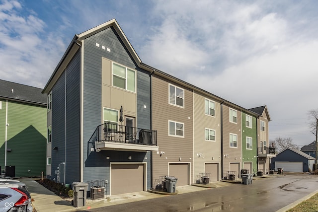 exterior space with a garage and central air condition unit