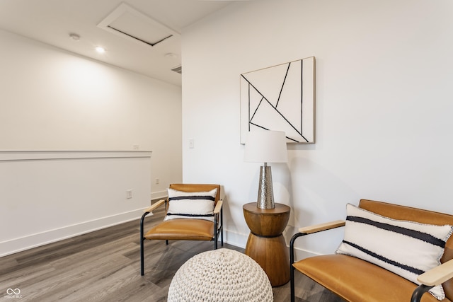 living area featuring attic access, baseboards, wood finished floors, and recessed lighting