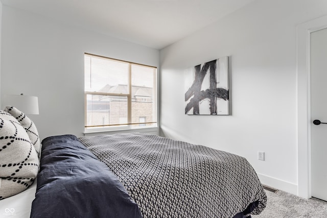 bedroom with carpet floors, baseboards, and visible vents