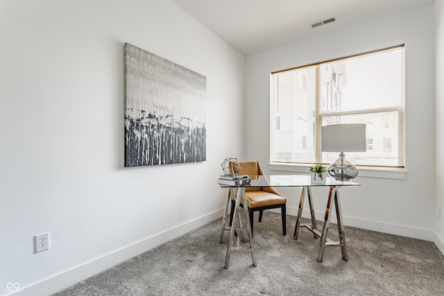 carpeted office with baseboards and visible vents