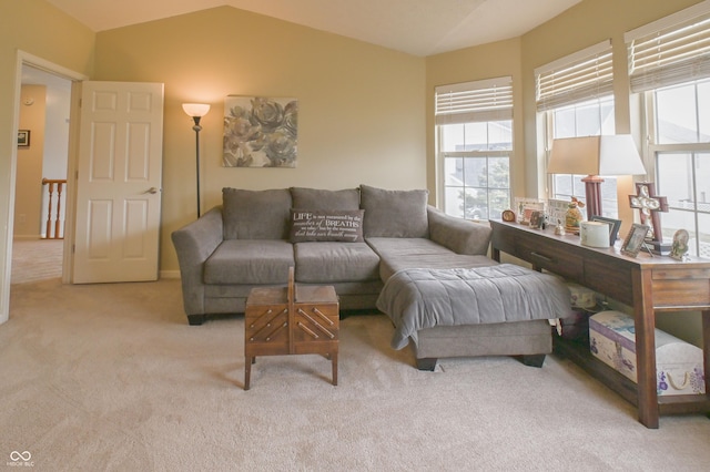 carpeted living room featuring vaulted ceiling
