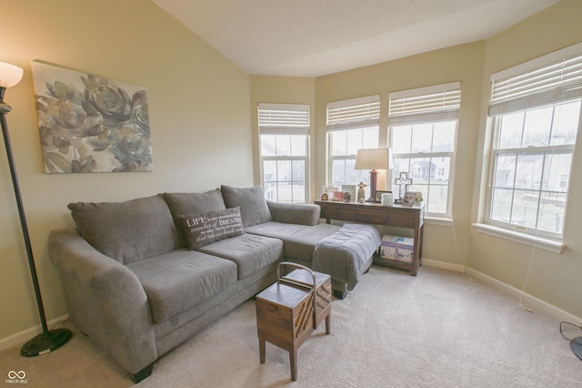 living room featuring baseboards, vaulted ceiling, and light carpet