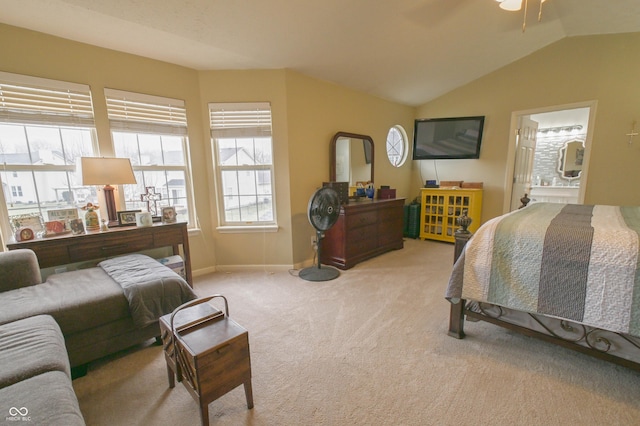 bedroom featuring light colored carpet, ensuite bath, vaulted ceiling, and baseboards