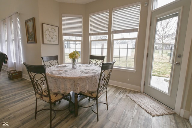 dining area with wood finished floors and baseboards