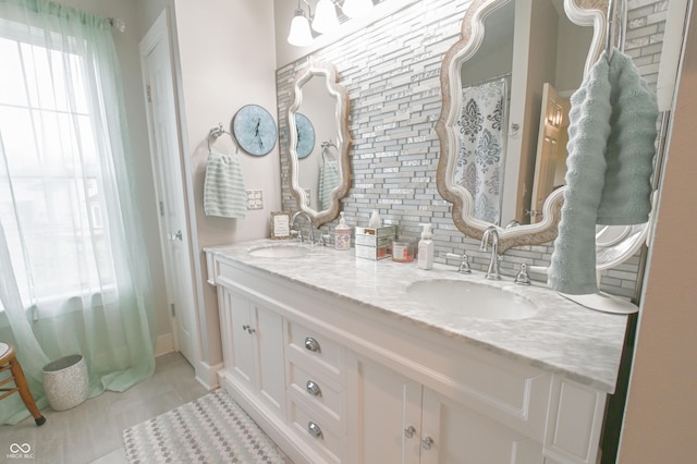 bathroom with tile patterned flooring, double vanity, and a sink