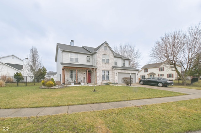 traditional-style home with a garage, concrete driveway, a front lawn, and fence