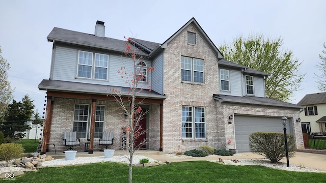 traditional home featuring a porch, a garage, a chimney, concrete driveway, and fence