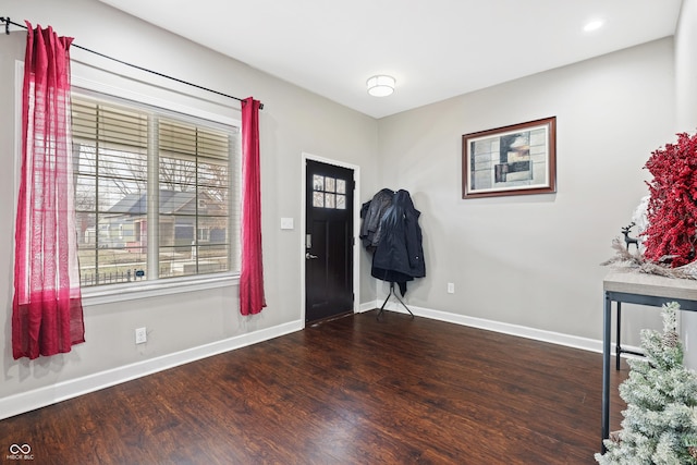 foyer featuring baseboards, dark wood-type flooring, and recessed lighting