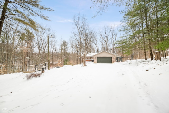 yard layered in snow with an attached garage