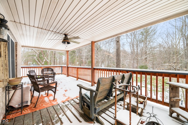 deck with outdoor dining space and ceiling fan