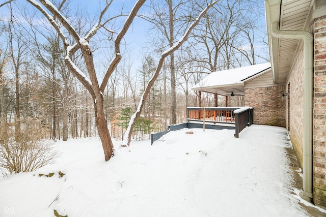 snowy yard with a wooden deck