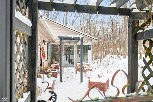 snow covered patio with a sunroom