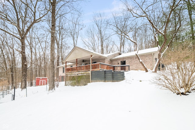 view of front of property with brick siding and a ceiling fan