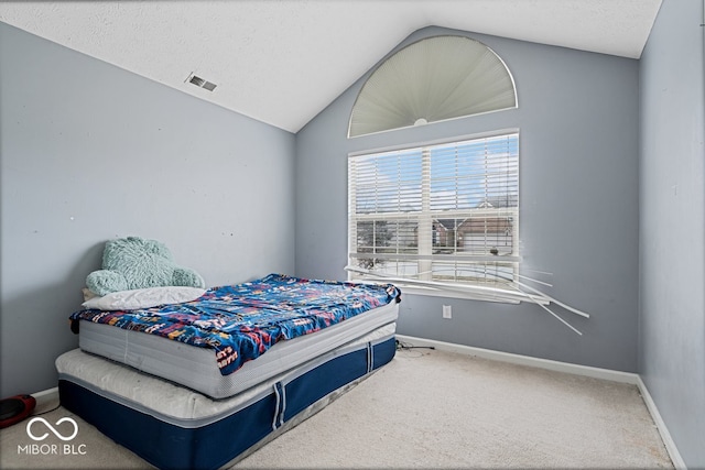 carpeted bedroom featuring vaulted ceiling, a textured ceiling, visible vents, and baseboards