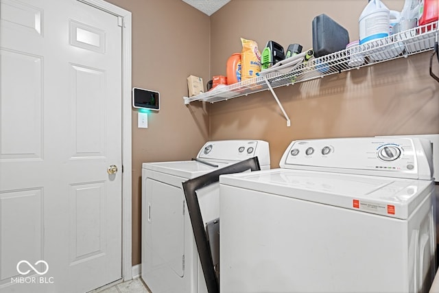 laundry room with laundry area and washing machine and clothes dryer